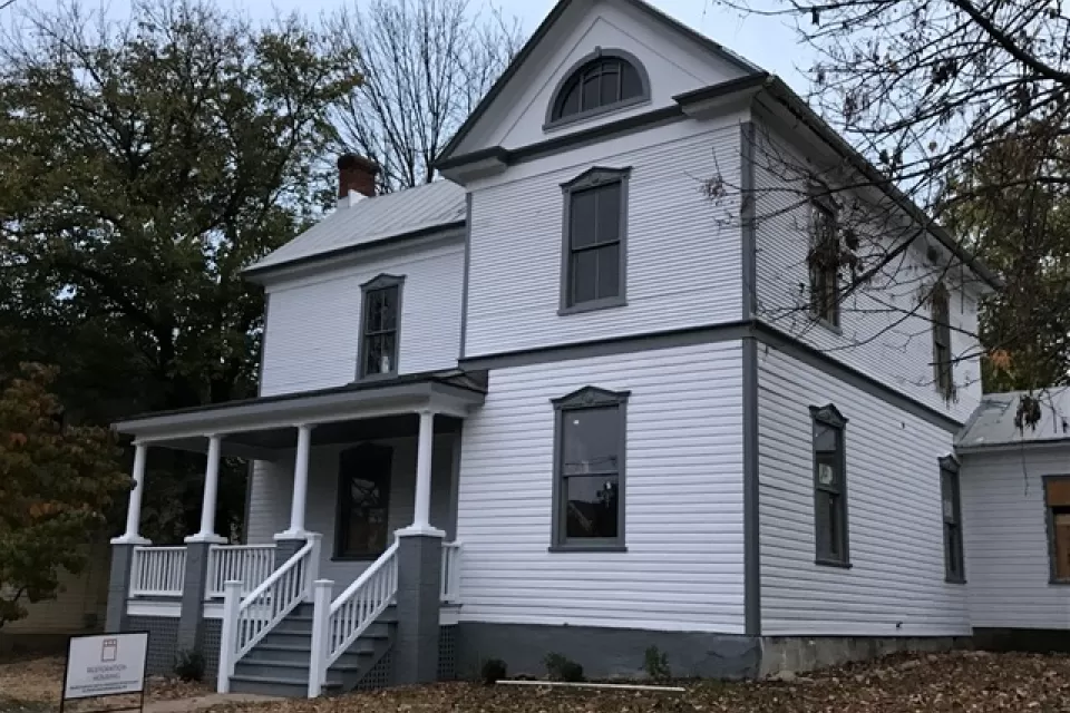 Restored white two-story historic home with black trim in Roanoke, Virginia